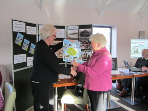 The Mayor of Aberaeron, Mrs Owenna James, welcomes the new Town Photo Trail from Clare Thomas on behalf of Cymdeithas Aberaeron Society